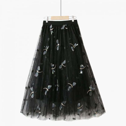 Elegant black tulle midi skirt with floral embroidery, perfect for summer chic fashion.