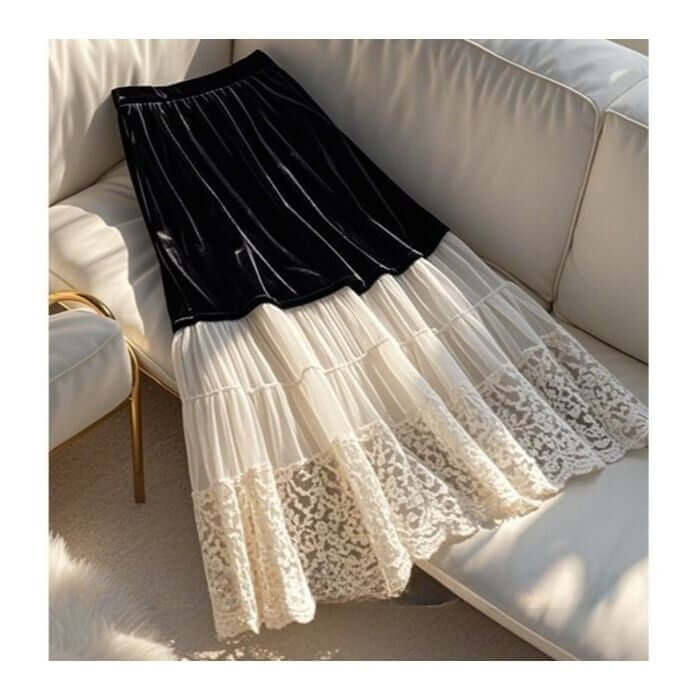 Stylish black and cream layered velvet lace women's skirt draped elegantly on a light sofa.