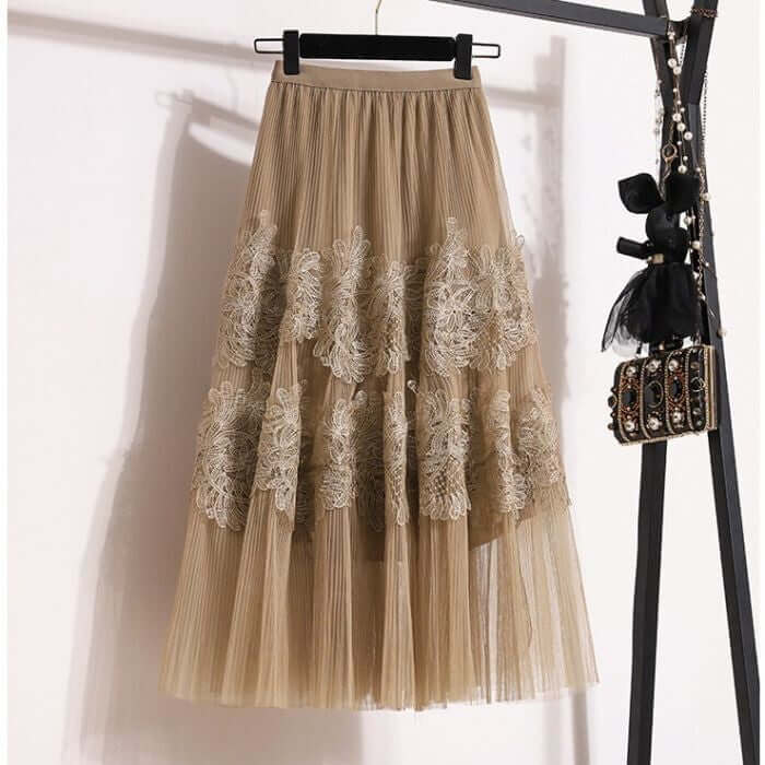 Elegant beige layered midi skirt featuring floral lace detailing, perfect for a stylish and chic wardrobe.
