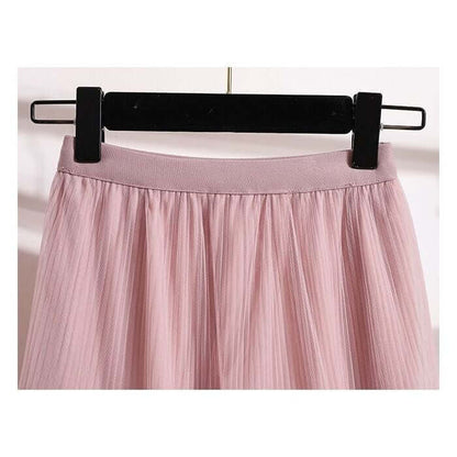 Close-up of the waistband and layered design of a pink tulle midi skirt, showcasing its delicate and stylish appearance.