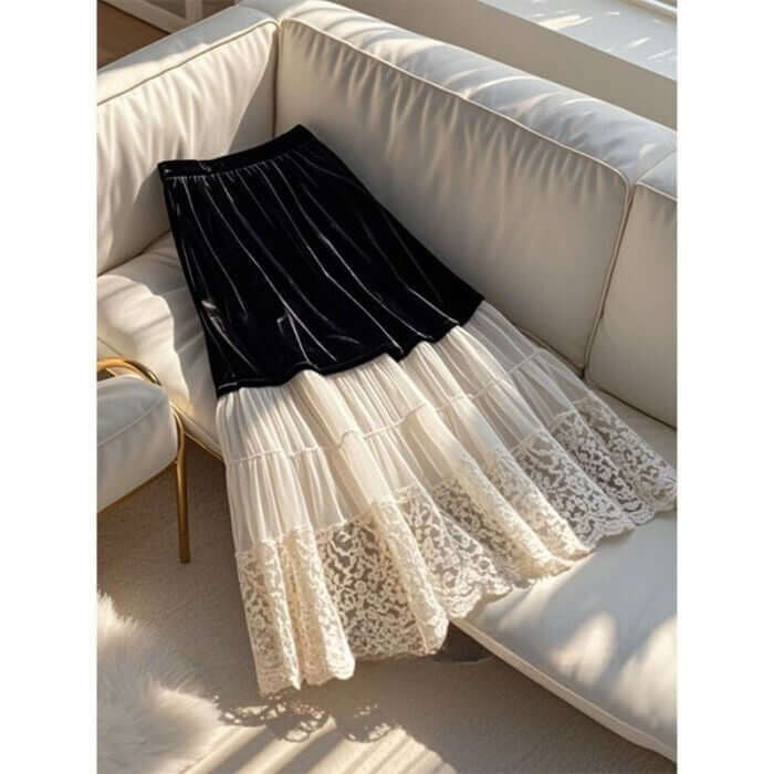 Velvet Lace Dream black and cream women's skirt styled on a sofa, featuring layered lace and a chic design.