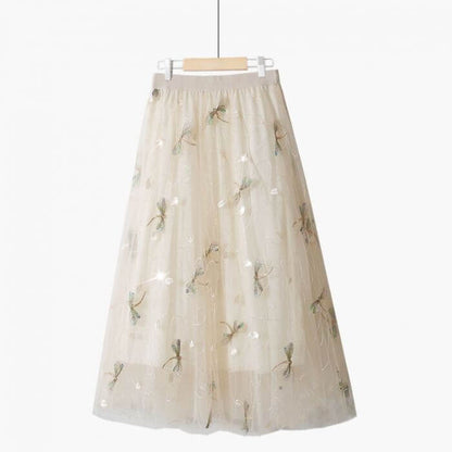 Elegant layered beige tulle skirt with floral embroidery, perfect for summer outfits and stylish occasions.