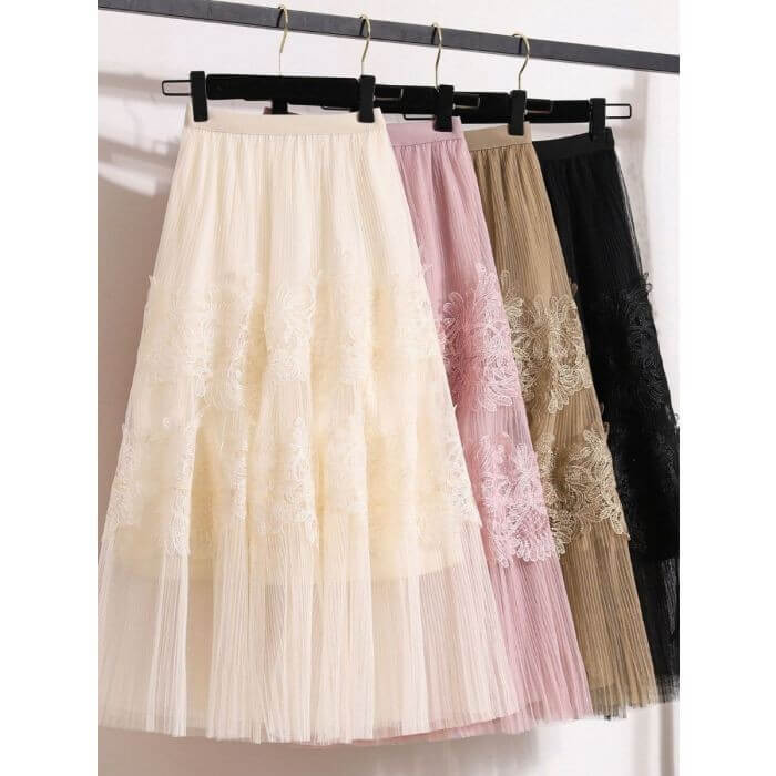 Elegant layered midi skirts in cream, pink, beige, and black tulle with lace embellishments, perfect for stylish outfits.