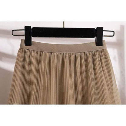 Close-up of beige pleated skirt waistband on hanger, showcasing stylish and comfortable design for women.