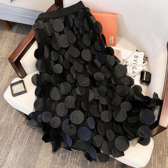 Elegant black midi skirt with large circle embellishments, showcasing a stylish and comfortable design for women.