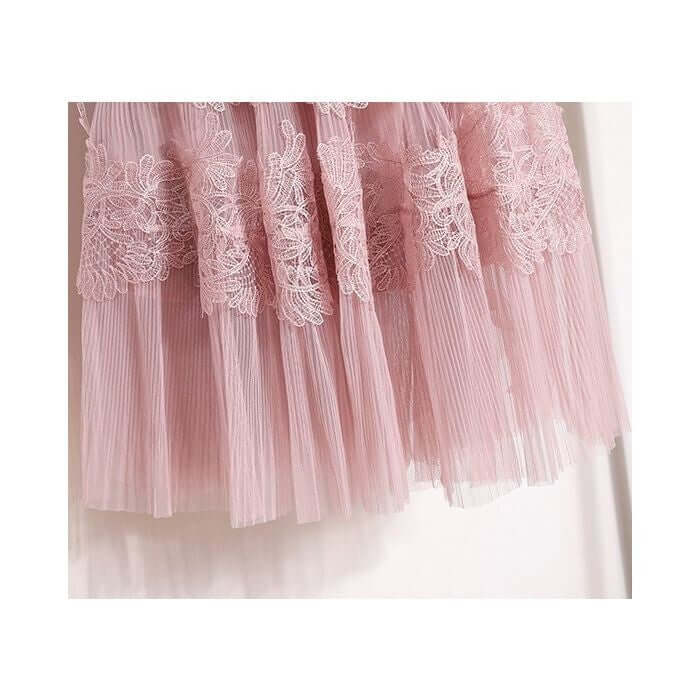 Elegant layered pink tulle midi skirt with decorative lace embellishments, perfect for stylish occasions.