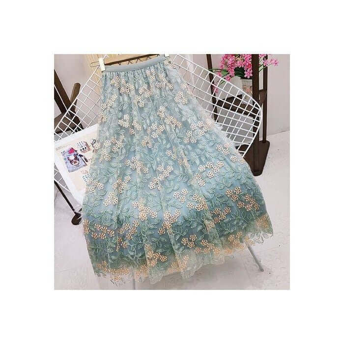 Elegant layered green tulle maxi skirt with floral embroidery, perfect for stylish summer outfits.