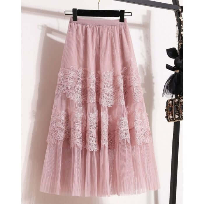 Stylish pink lace and tulle midi skirt showcasing layered design and elegant floral details for a chic look.