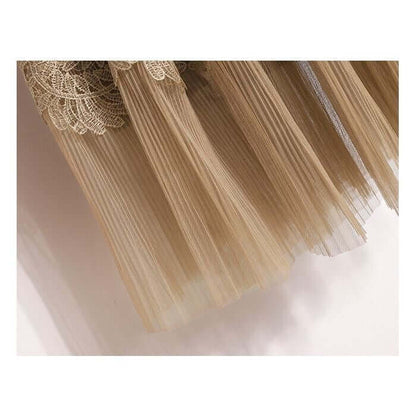 Close-up of elegant beige lace and tulle layered fabric for a stylish women's midi skirt.