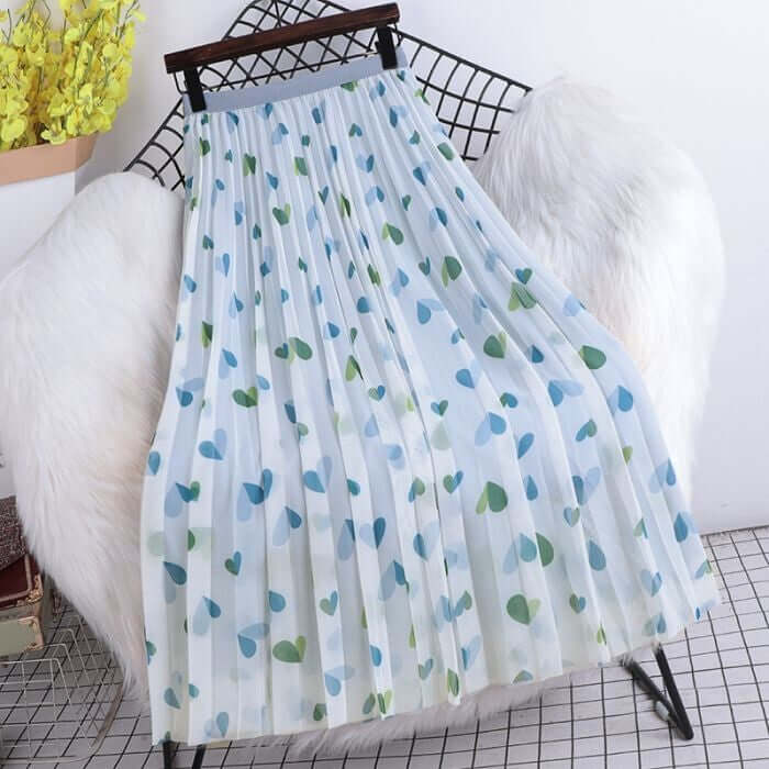 Pleated midi skirt with a hearts pattern in blue and green, showcasing a stylish and comfortable design on a display stand.