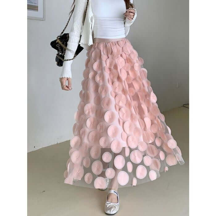 Stylish large circle embellished midi skirt in layered pink tulle, perfect for a chic and comfortable outfit.