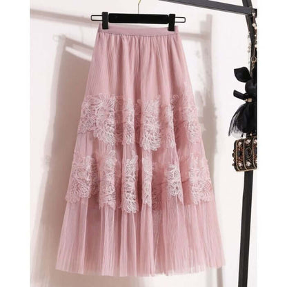 Elegant layered pink tulle midi skirt with lace detailing, perfect for a chic and stylish look.