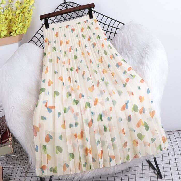 Pleated midi skirt with a hearts pattern in soft pastel colors, stylish and comfortable for women's fashion.