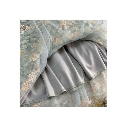 Elegant layered tulle fabric with floral embroidery and smooth satin for stylish midi women's skirts.