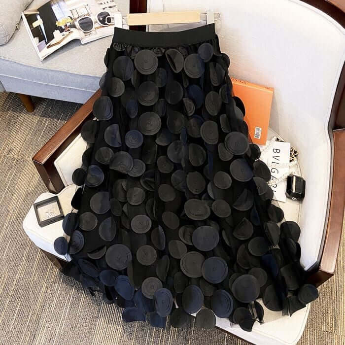 Elegant black circle embellished midi skirt with layered design, perfect for stylish and chic women's fashion.