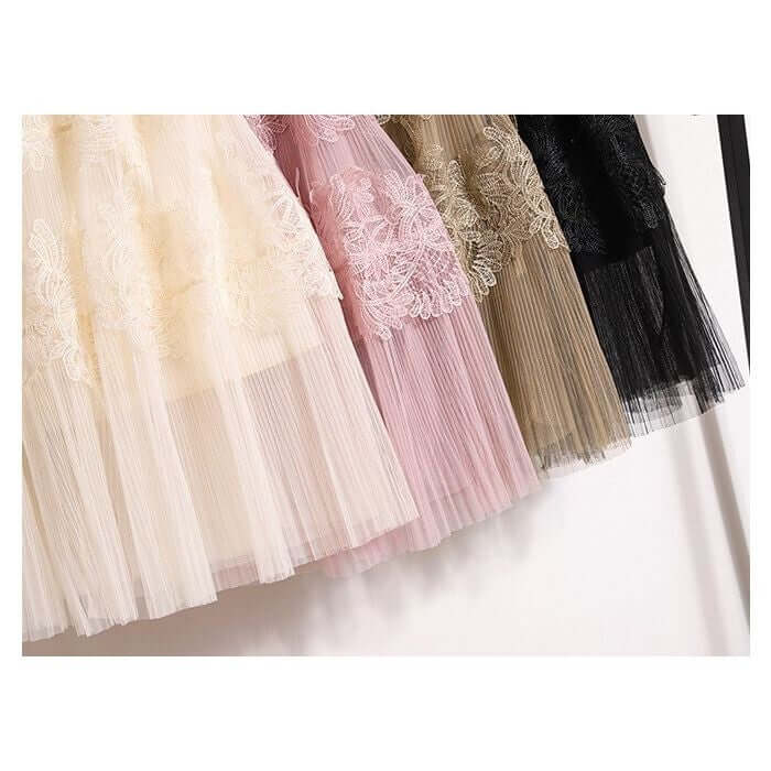 Elegant lace and tulle midi skirts in pastel and dark colors hanging on a display, showcasing a chic fashion choice.